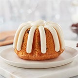 Gluten free chocolate chip cookie Bundtlet showing topped with signature frosting