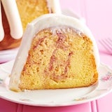 Lemon raspberry slice showing topped with signature frosting