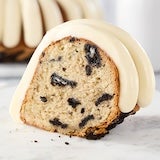 OREO Cookies & Cream slice showing topped with signature frosting and oreo crumbles inside slice of cake