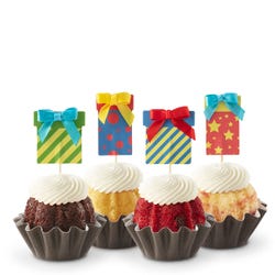 Cupcake-sized mini cakes with frosting and birthday present toppers with different celebratory designs.