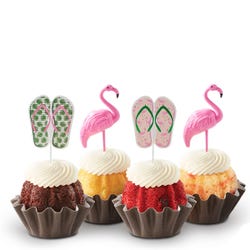 Mini bundt cakes decorated with a topper: from left to right, there's a pair of green tropical flip-flops, a pink flamingo, another pair of pink flip-flops with green straps, and another pink flamingo.