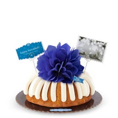 Happy Hanukkah celebration cake with a decorative bow in the center.
